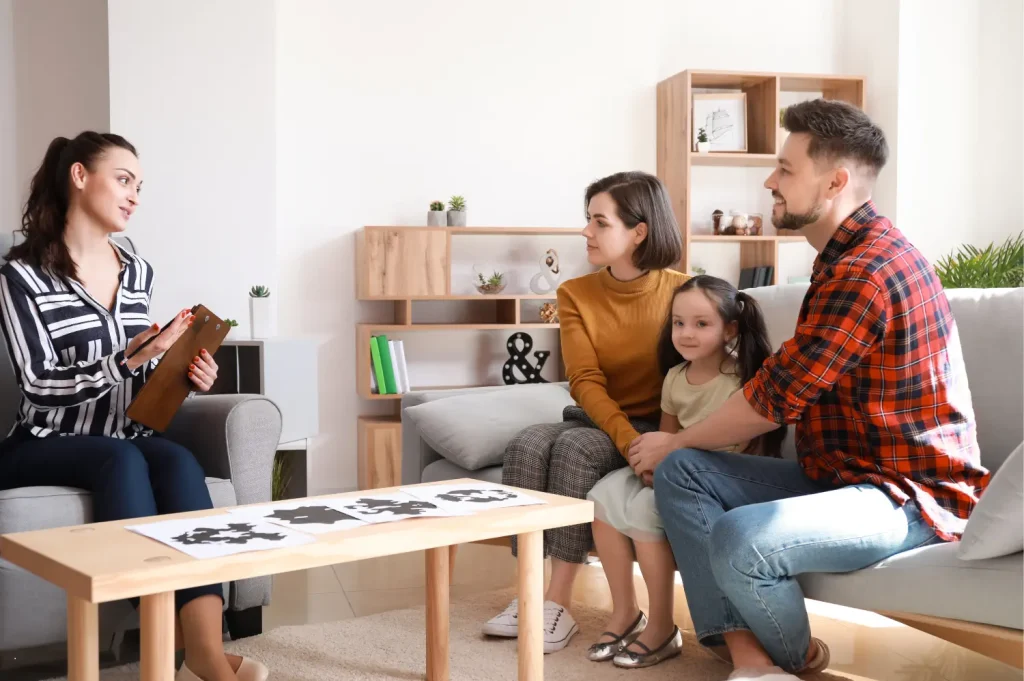 family addiction therapy program showing a therapist guiding a family with a young child during a supportive session.