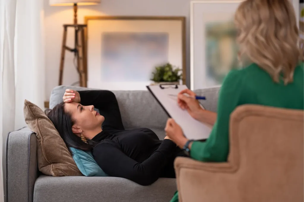 local outpatient rehab featuring a woman talking with a therapist while reclining in a calm, private office