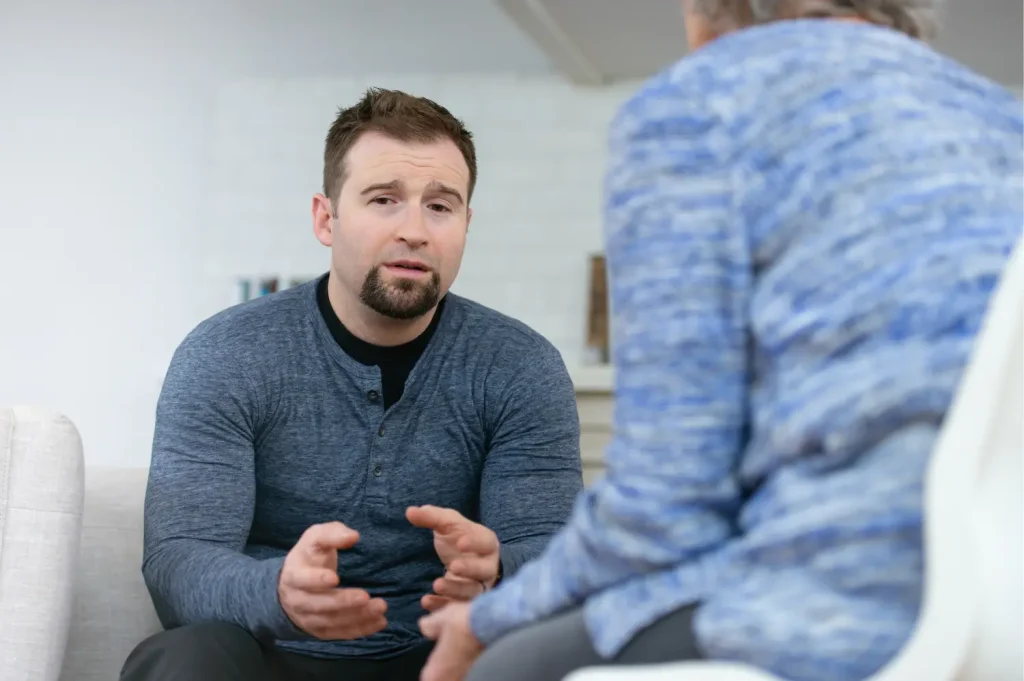 mental health treatment featuring a therapist listening attentively to an emotional client during a private session