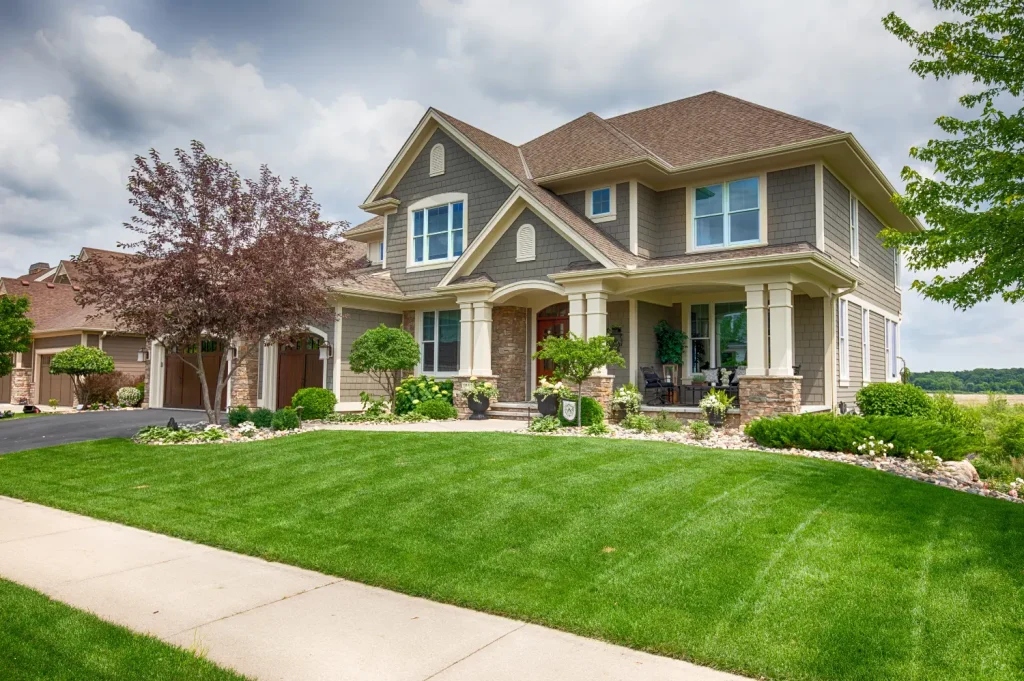 transitional homes for recovery showcasing a large suburban home with manicured lawn and welcoming front porch