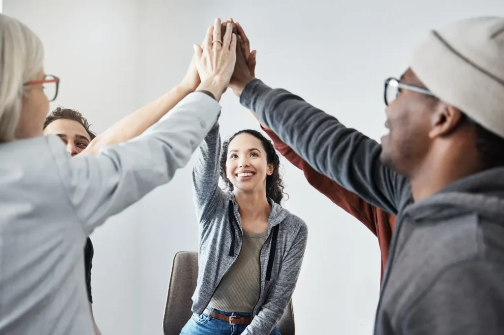 Detox programs participants celebrating progress together in a supportive recovery group setting.