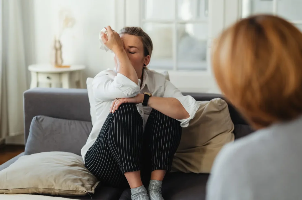 Programs for addiction recovery depicted with an emotional therapy moment during an individual counseling session.