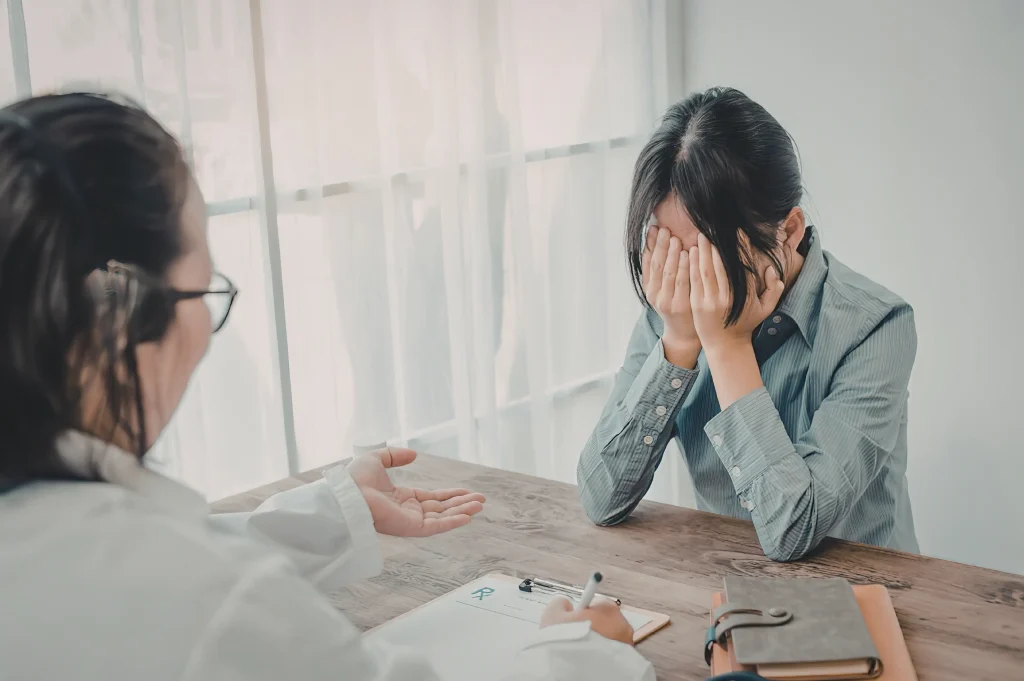 Therapist offering support to a distressed client during a personalized addiction treatment counseling session